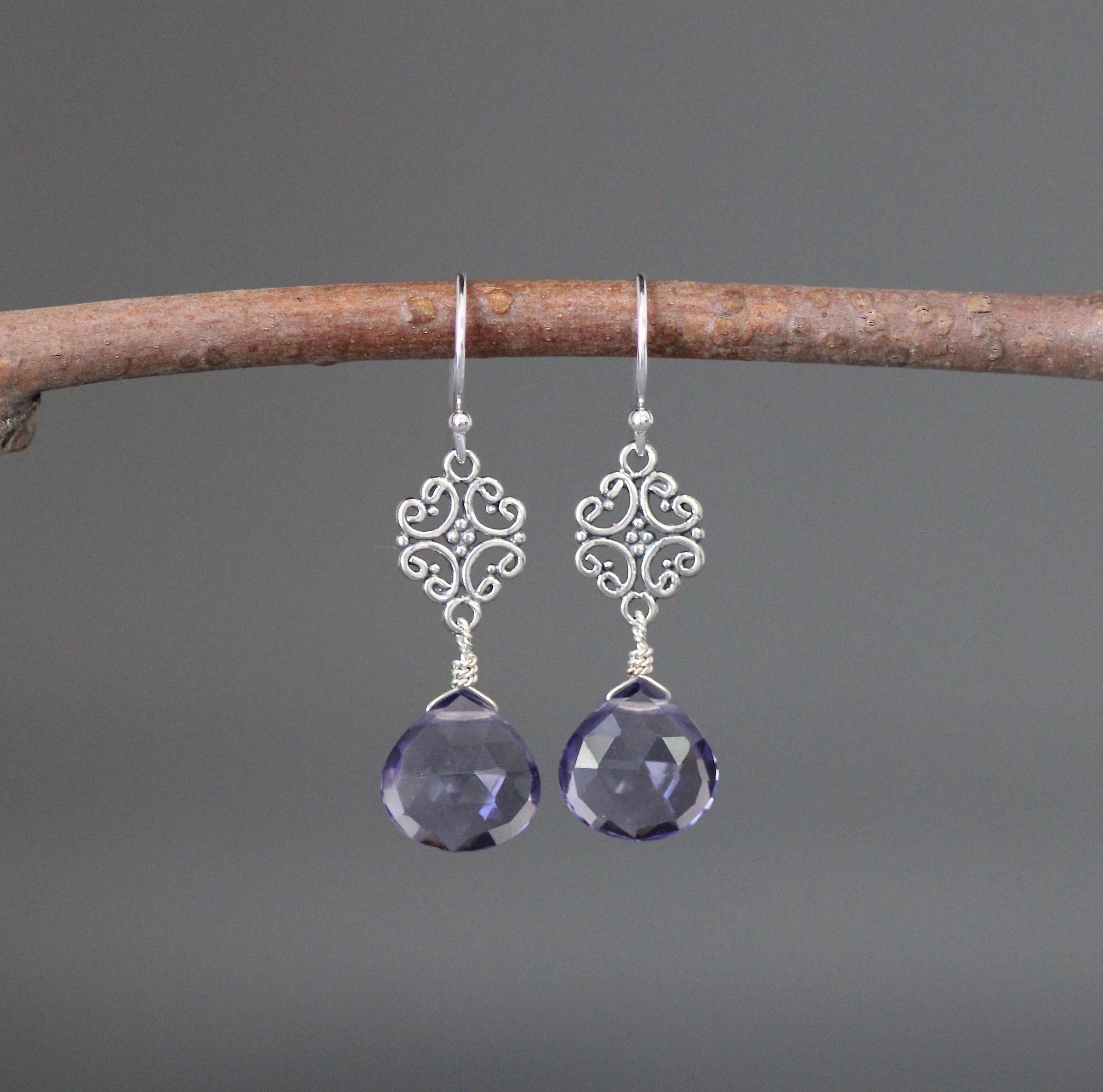 Sterling silver filigree teardrop earrings with blue-violet faceted stones