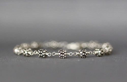 Sterling silver beaded bracelet with round textured beads and chain links