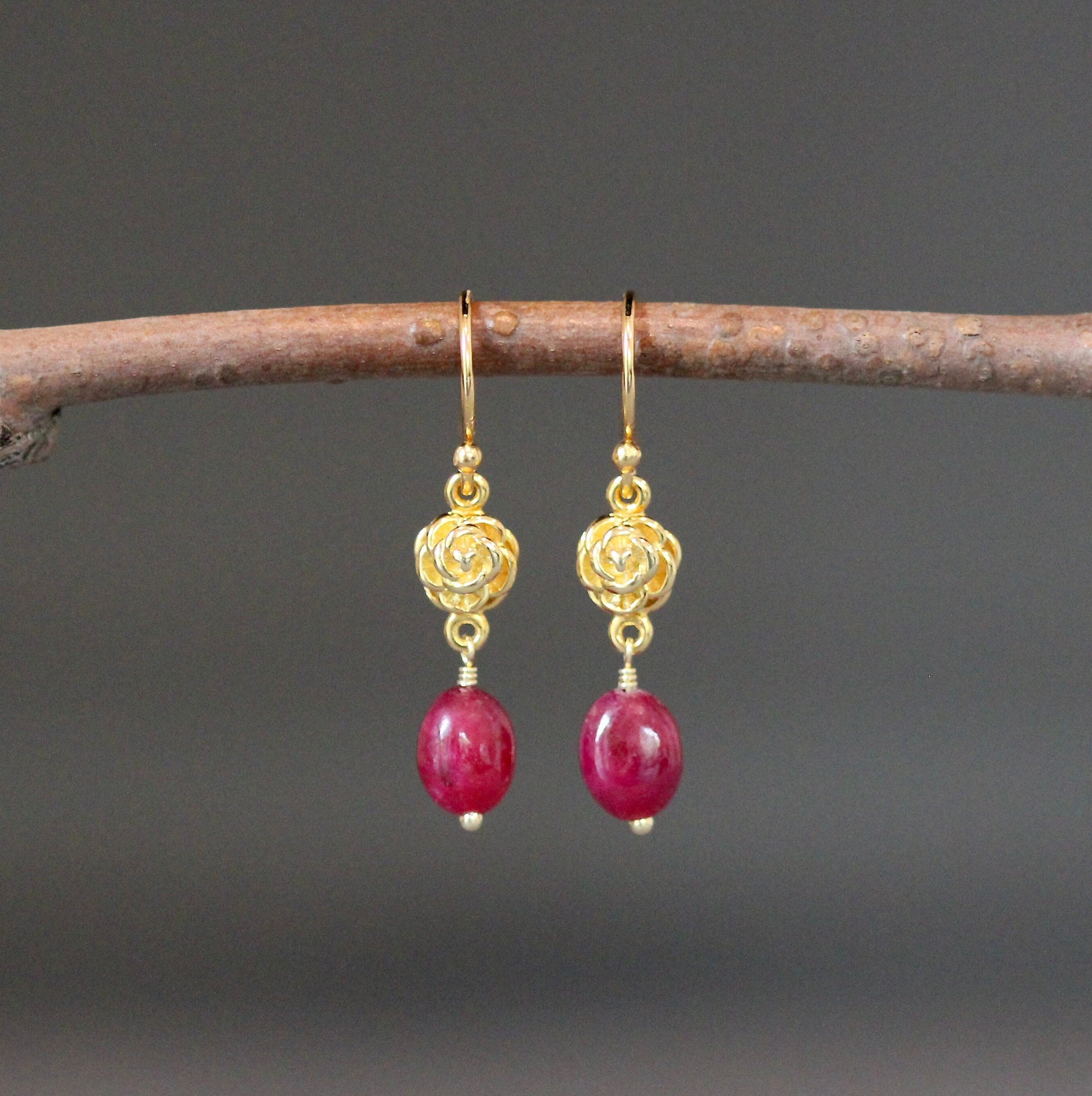 Gold-tone rose-flower dangle earrings with pink teardrop beads and gold hooks