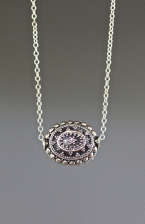 Sterling silver round filigree bead pendant necklace with blue inset centerpiece