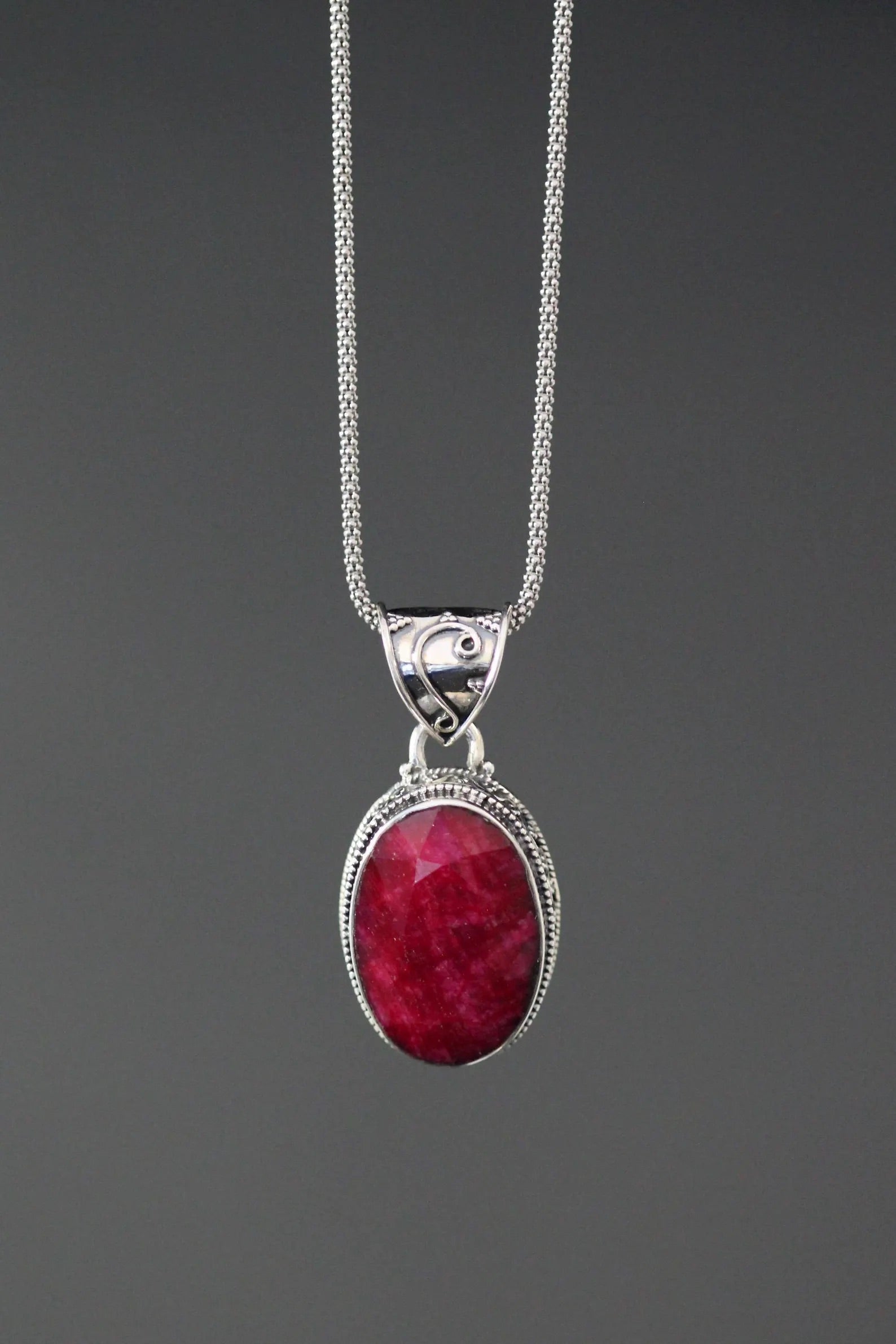 Sterling silver ruby red oval pendant necklace with ornate bail and fine chain