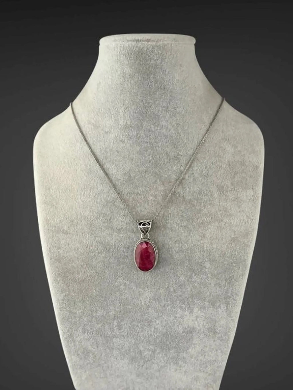Sterling silver ruby-red oval pendant necklace on mannequin bust
