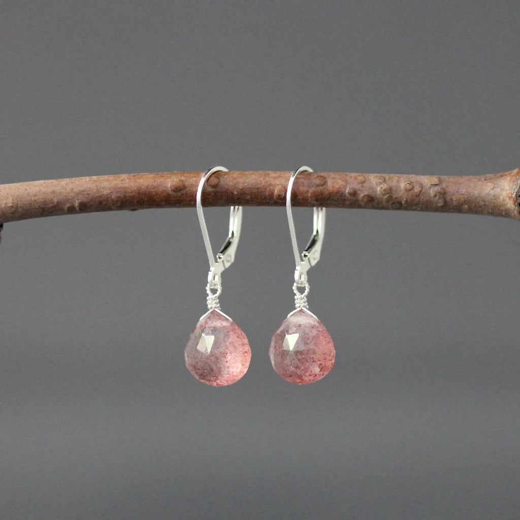 Strawberry quartz and silver earrings against a gray backdrop